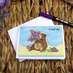 Spring bear smelling lilacs greeting card